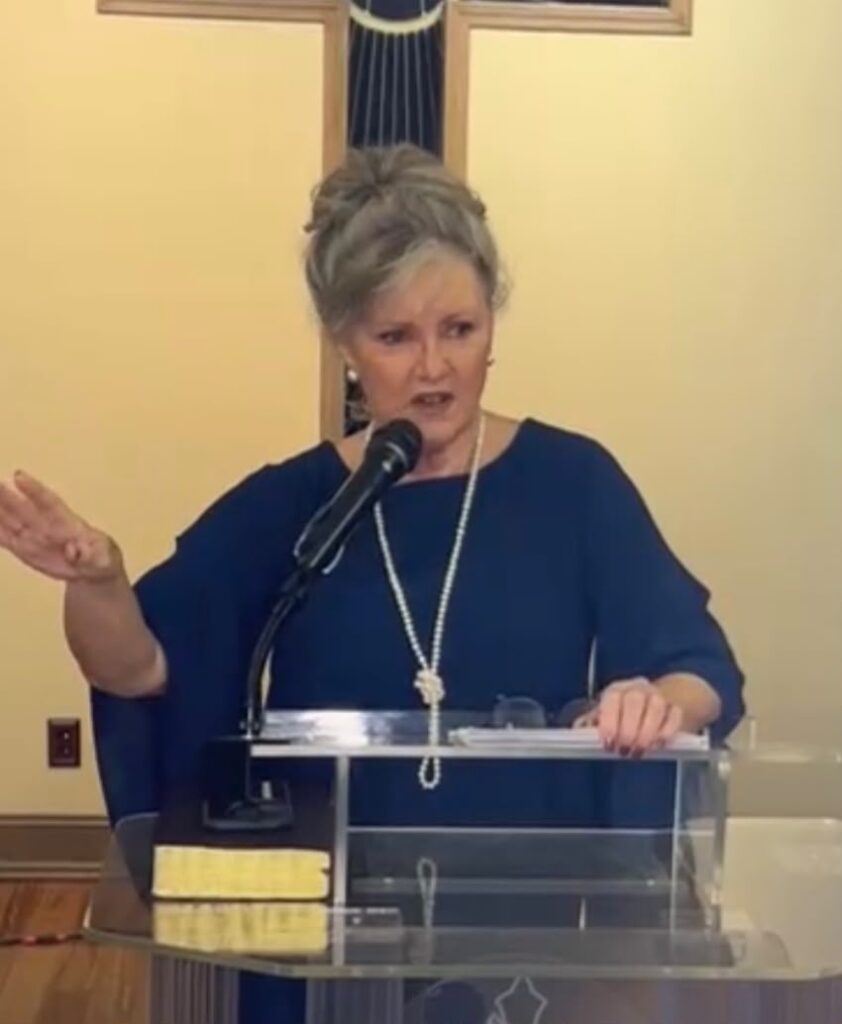 Photo of Glenda Watson speaking wearing a navy blue top